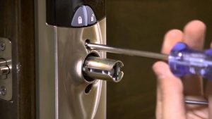 A Locksmith Fixing a Door Lock