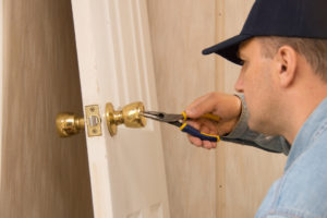 A Professional Locksmith Fixing a Door Lock