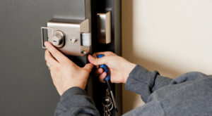 A Professional Locksmith Fixing a Door Lock