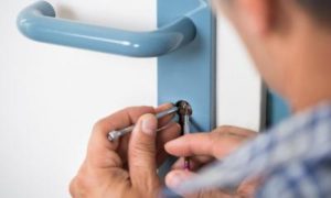 A Professional Locksmith Fixing a Door Lock